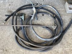 A quantity of petrol pump hoses, some with nozzles, a brass tank measure etc.