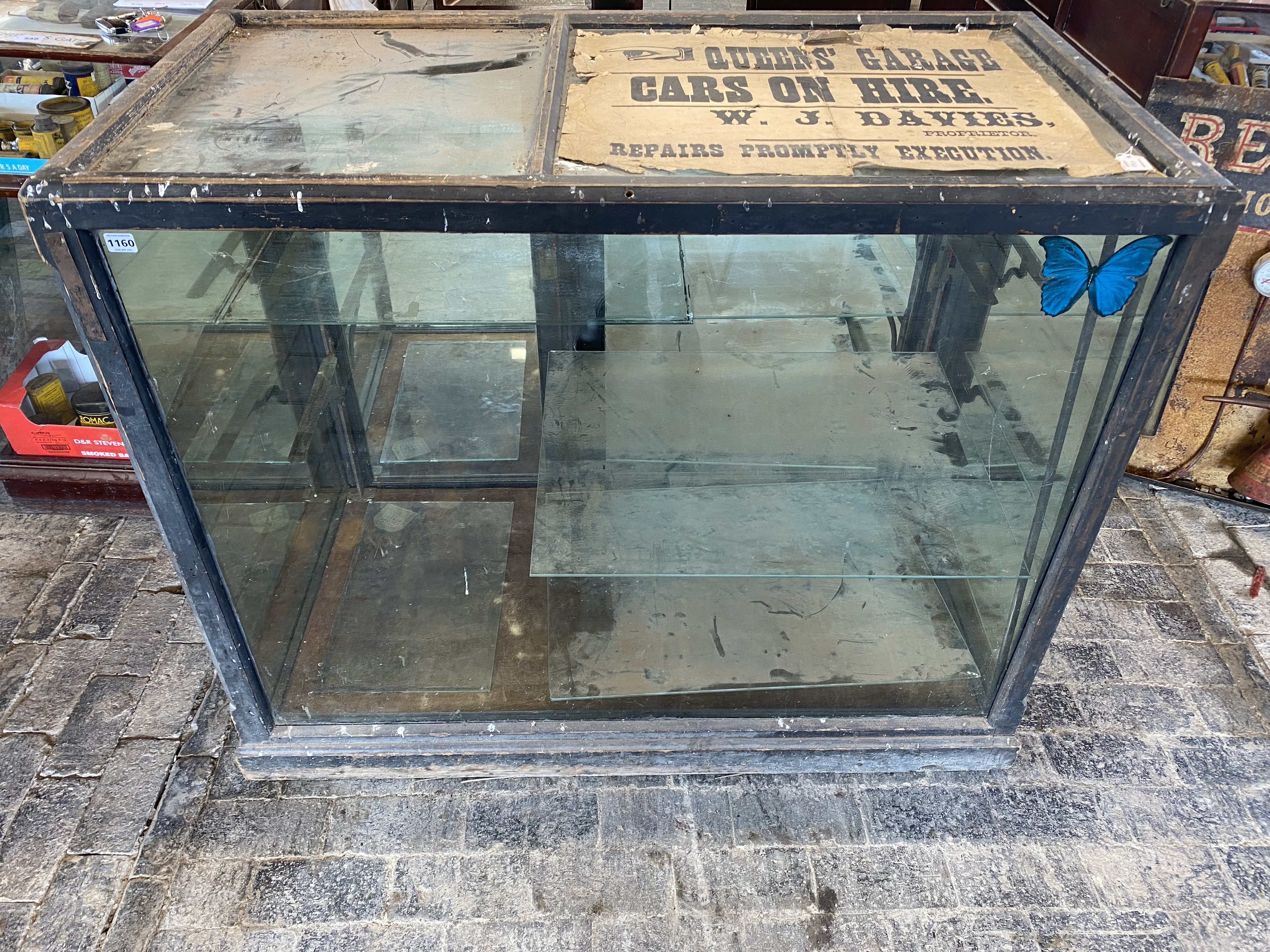 A large Edwardian mirror backed glass and wooden framed display cabinet, with two rear opening