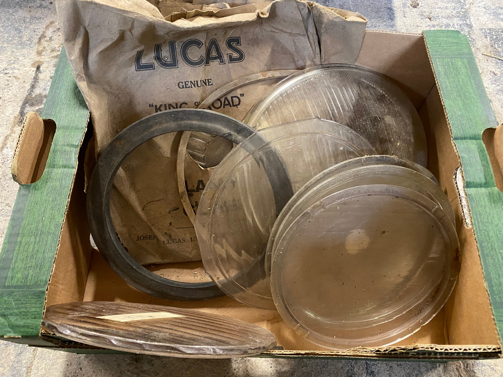A small box of headlamp glasses, some in original packaging.