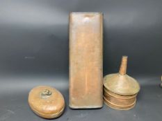 Two copper foot warmers and a large copper funnel.