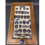 A framed group of Morris badges, assorted models.