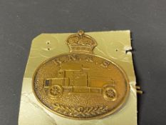 A Royal Naval Armoured Service oval lapel/cap badge.