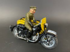 A small die-cast model of an AA motorcycle combination with rider, marked Made in England.