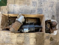 A box of starter motors and various pulleys.