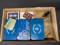 A selection of RAC collectables including buttons, playing cards, box keys and first aid tins.