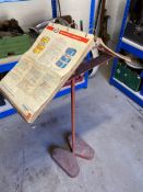 A 1960s garage workshop metal stand with a quantity of Esso service guides, lubrication charts etc.