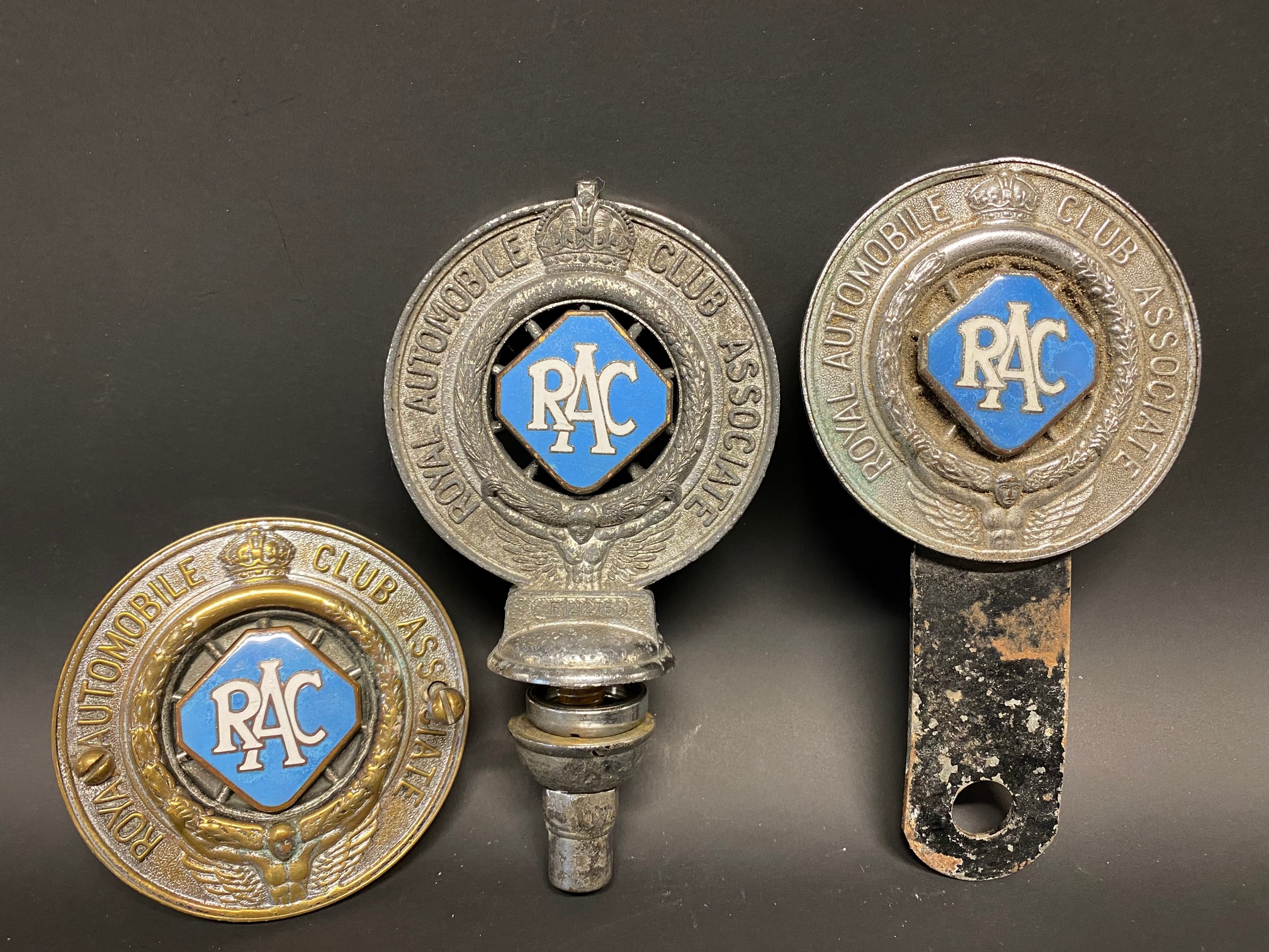 Three different version RAC Associate member badges, all with powder blue enamel centres.