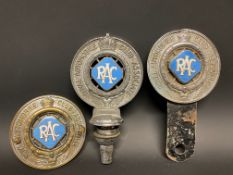 Three different version RAC Associate member badges, all with powder blue enamel centres.