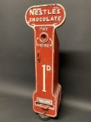 A Nestle's Chocolate wall mounted vending machine, 9 1/2" w x 29 1/2" h x 6 1/2" d.