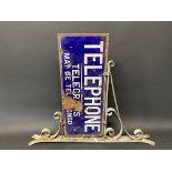 A Telephone - Telegrams May Be Telephoned double sided enamel sign, mounted on a wrought iron