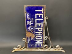 A Telephone - Telegrams May Be Telephoned double sided enamel sign, mounted on a wrought iron