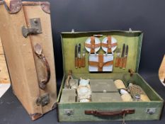 A cased picnic set and a suitcase.