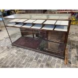 A large Victorian/Edwardian mahogany framed shop counter display cabinet, unusually having a high