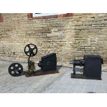 Two large cinema projectors, brass and steel..