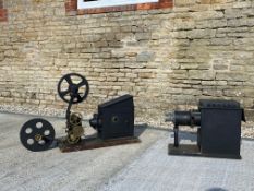 Two large cinema projectors, brass and steel..