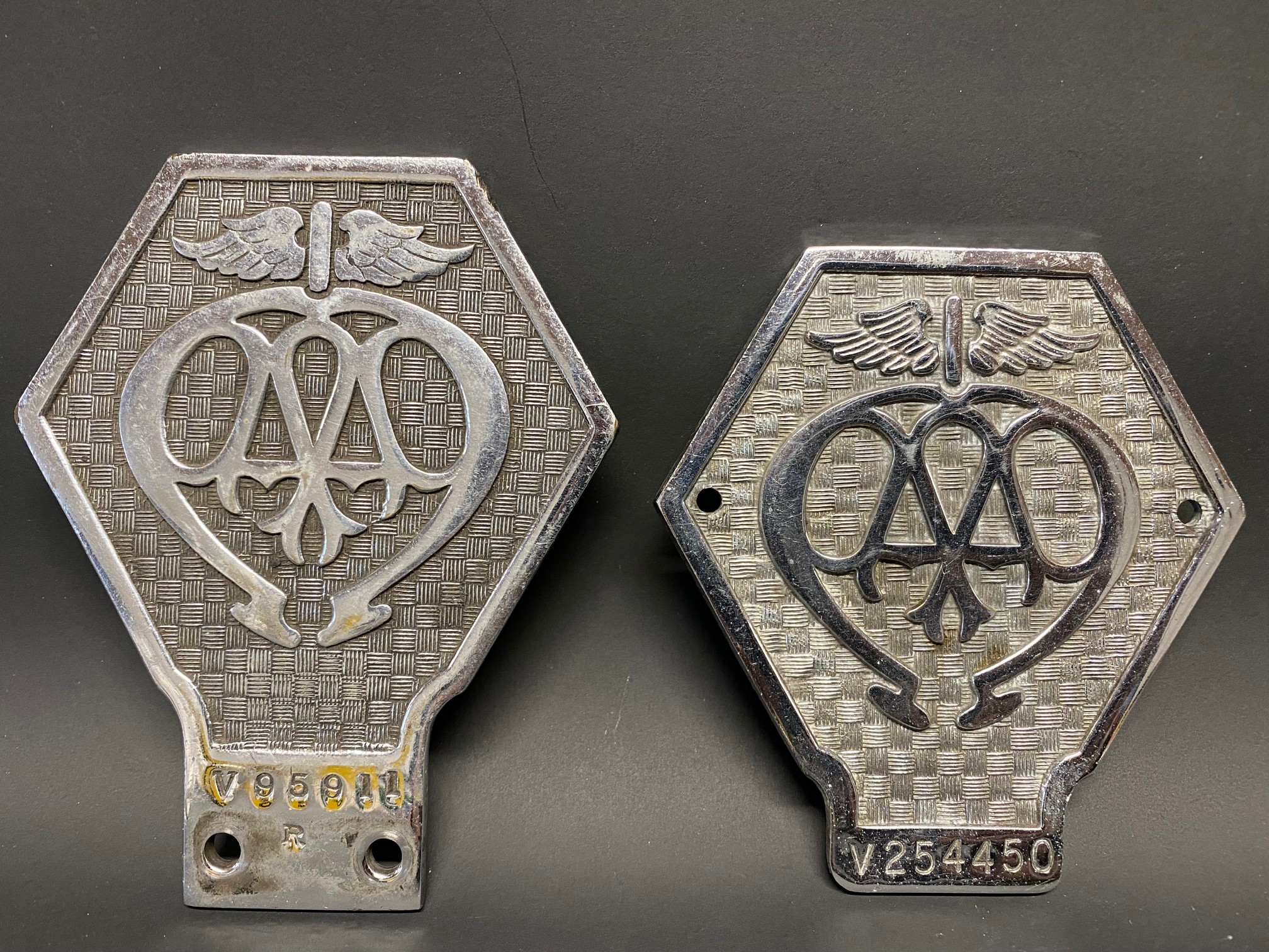 Two AA Commercial badges, V95911 and V254450.
