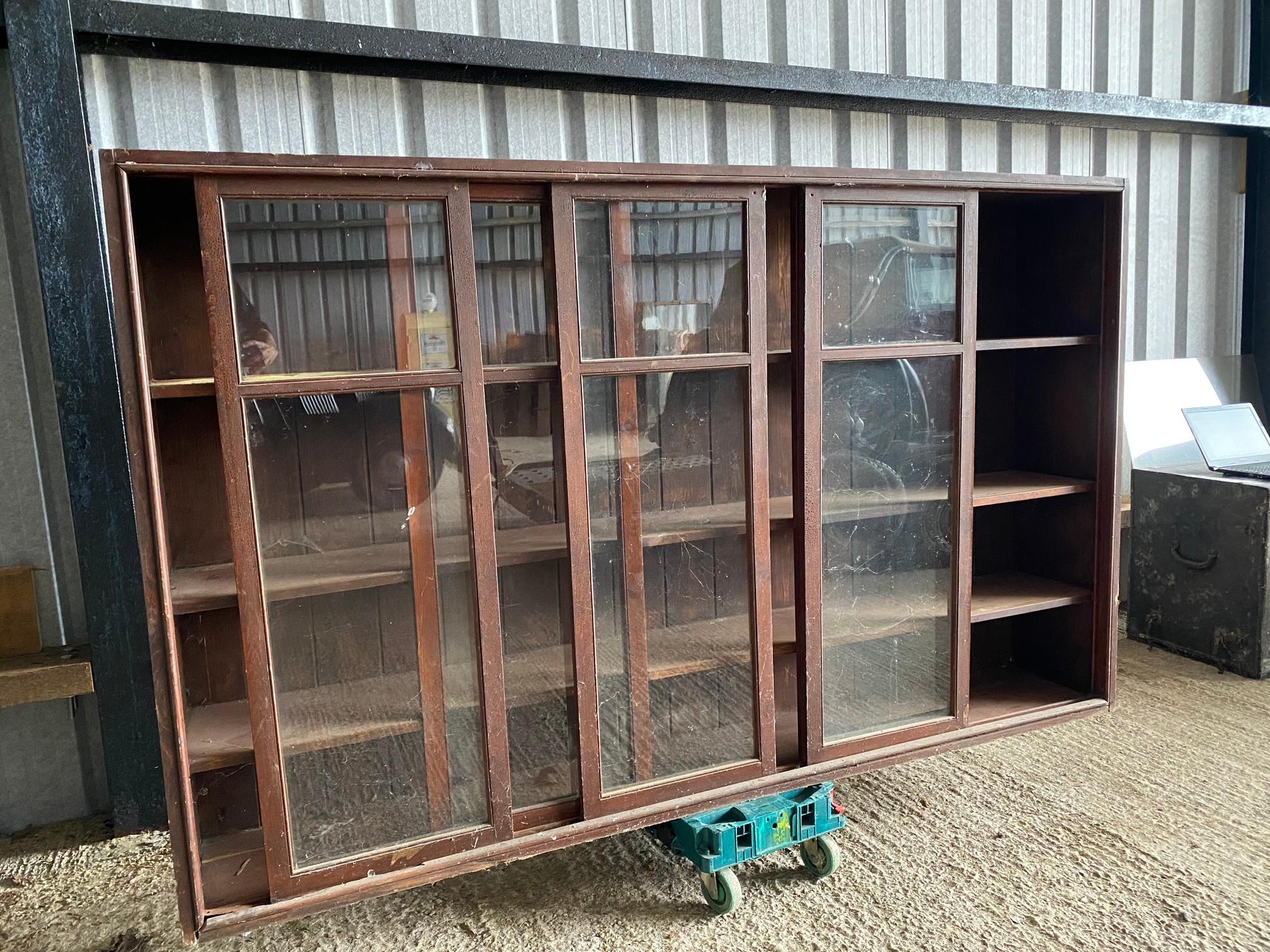 A large stained pine display cabinet with five sliding glass doors, 89 1/4" w x 54 1/2" h x 14 1/