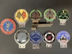 A selection of assorted car badges including Humber Register 1900-1930.