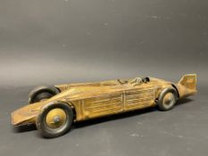 A clockwork tinplate model of Golden Arrow, the World Landspeed Record car.