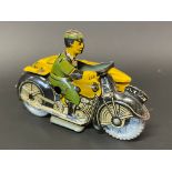 A small clockwork tinplate model of an AA motorcycle combination with rider, excellent condition.