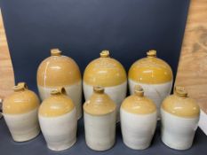 A selection of stoneware flagons, all with impressed lettering, Fishguard and Haverfordwest noted.