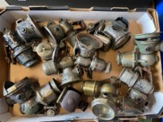 A box of cycle oil and carbide lamps.