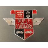 A Duple Group Coachwork chrome plated and enamel badge.