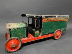 A large tinplate model of a delivery wagon, with advertising for Carter Paterson.