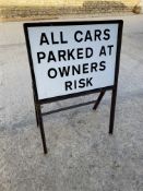 A metal sign bearing the words 'All Cars Parked At Owners Risk', 24 x 36".