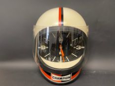 A rare Champion wall clock in the form of a racing helmet, in very good condition.
