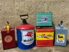 A large Motul oil can and four fuel cans of differing size, all with modern decals attached.