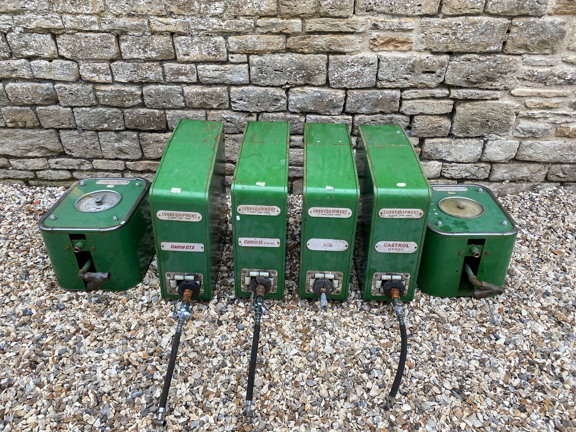 A six piece Castrol wall mounted greasing station.