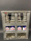 An Essolube eight division oil bottle crate containing four Esso Extra quart bottles and two