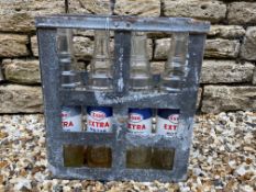 An Essolube eight division oil bottle crate containing four Esso Extra quart bottles.