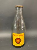 A Shell Triple Shell SAE 50 glass oil bottle with a good label.