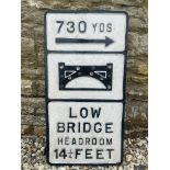 A 'Low Bridge Headroom 14 1/4 Feet' aluminium road sign, older repairs, 14 1/4 x 27 3/4".