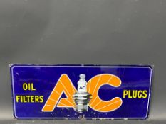 A small AC Oil Filters and Plugs enamel sign with central spark plug image, 21 x 9".