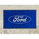A Ford showroom carpet mat, 58 x 33".