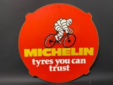 A Michelin 'tyres you can trust' pictorial hardboard advertising sign, 24" diameter.