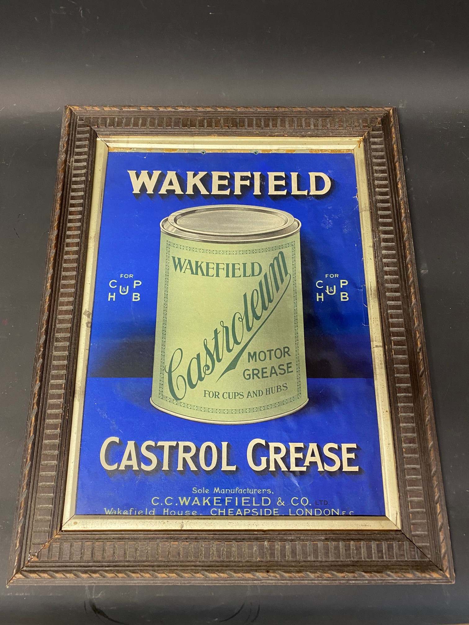 A Wakefield Castrol Grease pictorial showcard, in a wooden frame, 18 1/2 x 24".