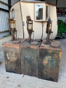 Three garage forecourt bulk oil drums, with original orange paint visible, probably Pratts.