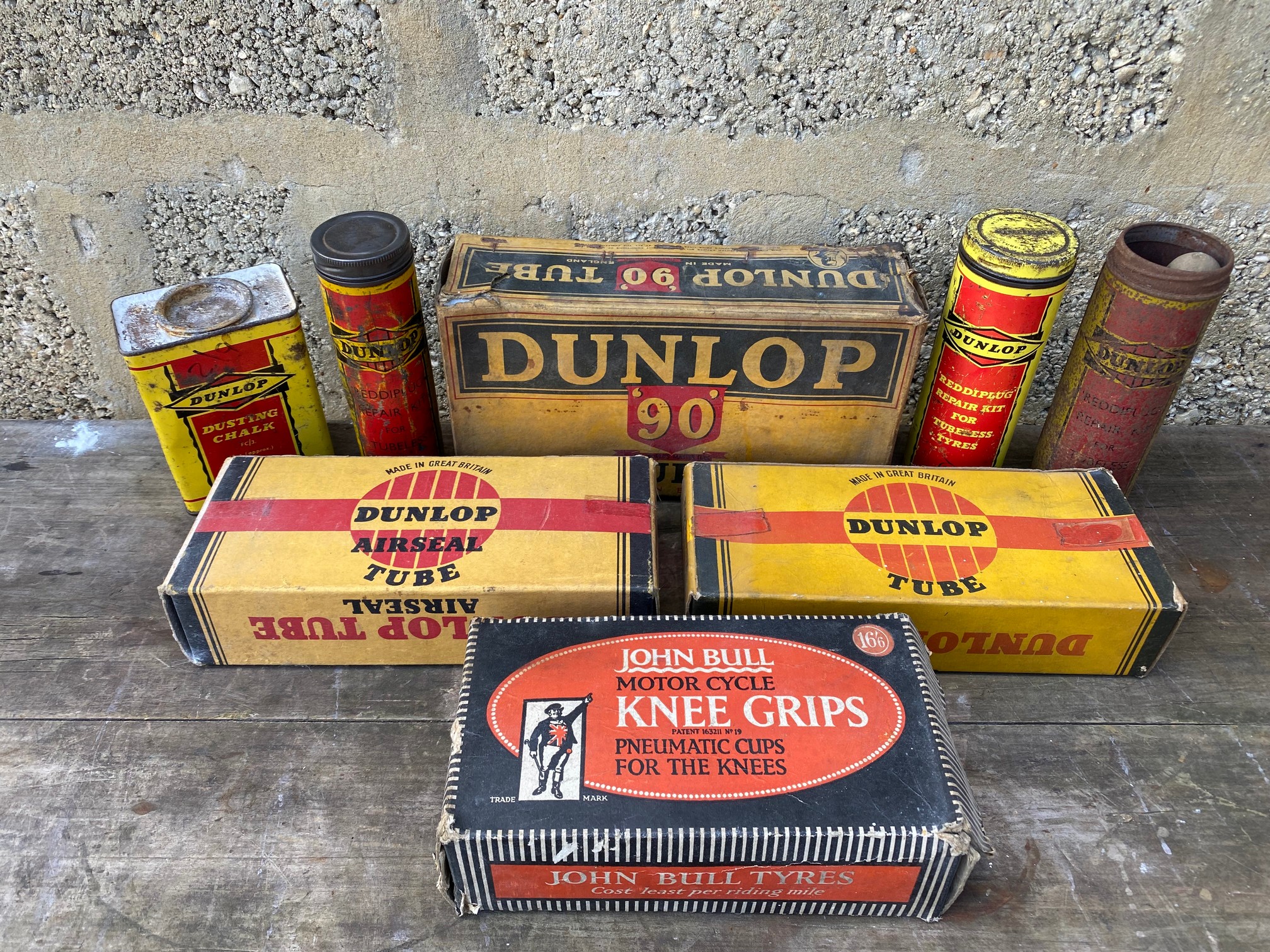 A quantity of Dunlop and John Bull packaging and tins.