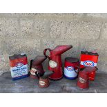 An Esso gallon measure, three other Esso measures and three Esso tins.