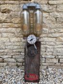 A French wall mounted petrol pump with Shell clam decals on each of the glass cylinders.