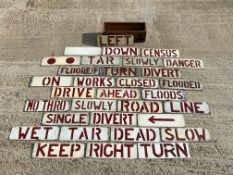 A collection of galvanised stencil bollard/road sign insert signs, in a wooden case.