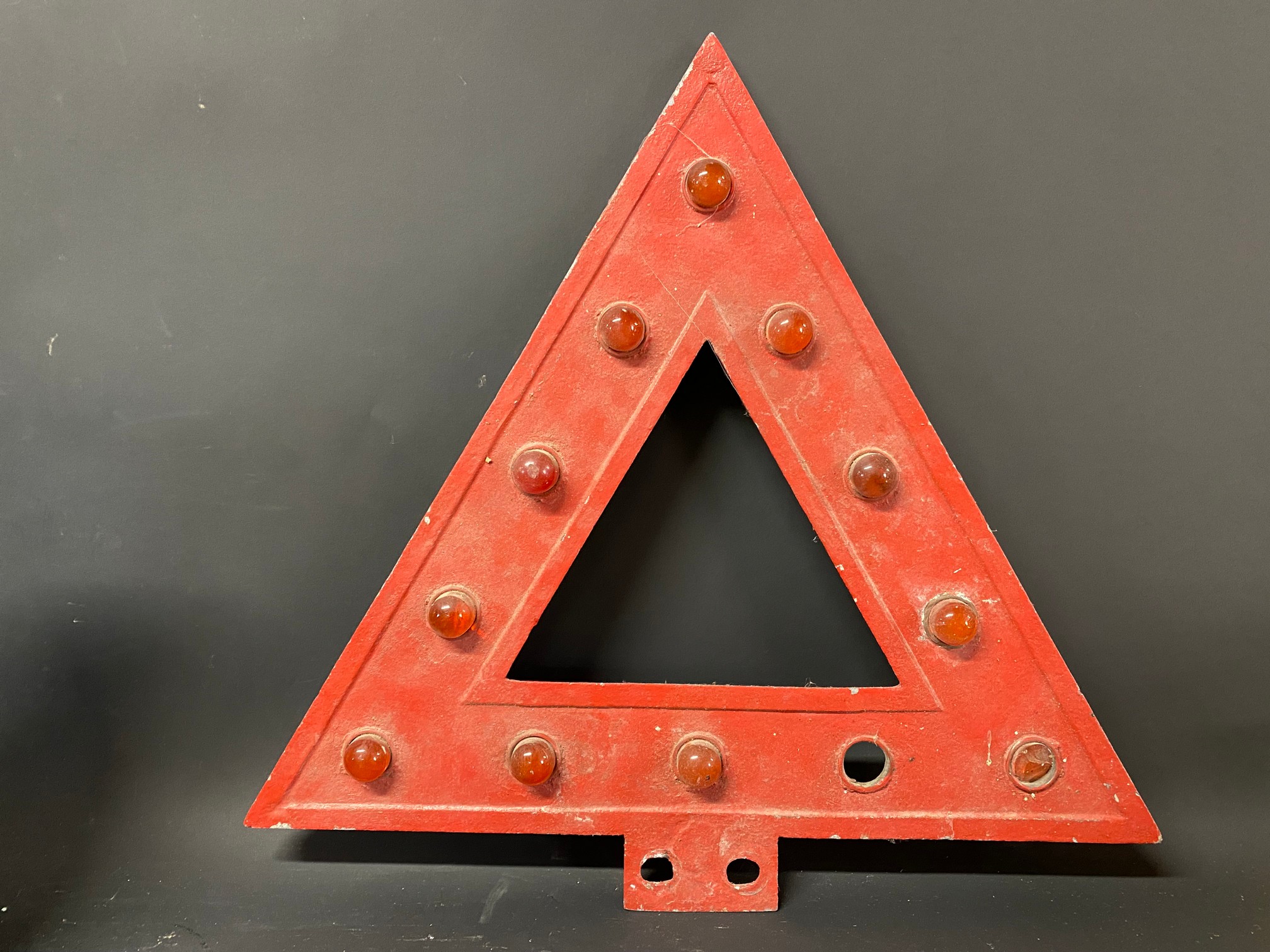 An aluminium triangular warning sign with integral red glass bead reflectors, 18 x 17 1/2".
