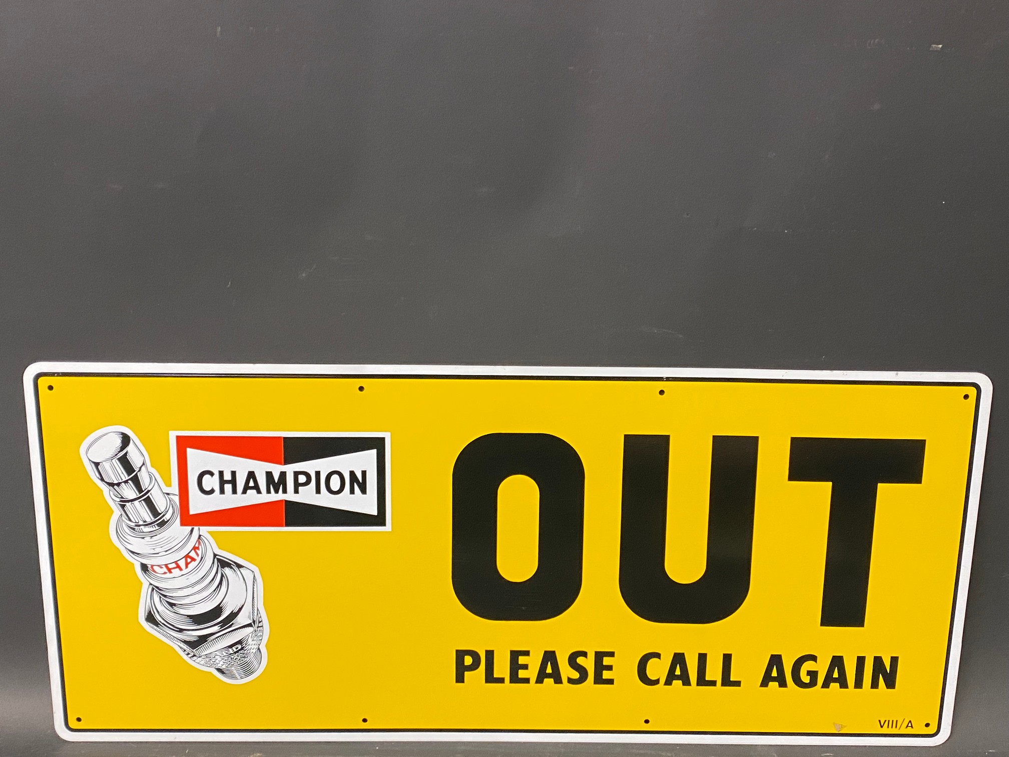 A new old stock Champion spark plug garage tin advertising sign 'Out', 23 x 10".