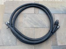Two 1" rubber petrol pump hoses with fittings attached.