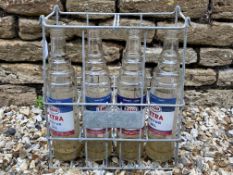 An eight division oil bottle crate containing four Esso Extra quart bottles.