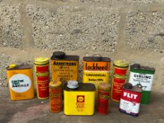A selection of assorted oil cans including Shell, plus four Dunlop puncture repair kit tins.